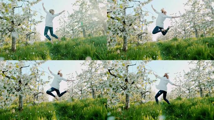 SLO MO欣喜若狂的女人在樱花中跳跃