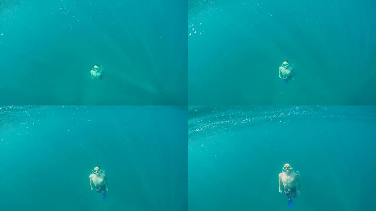 水下慢动作: 成年男子在海上浮潜，浮出水面呼吸