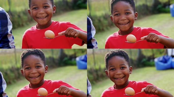 快乐男孩在后院拿着鸡蛋和勺子4k