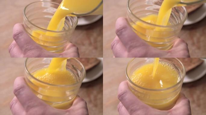 从水罐中倒入橙汁的慢动作镜头