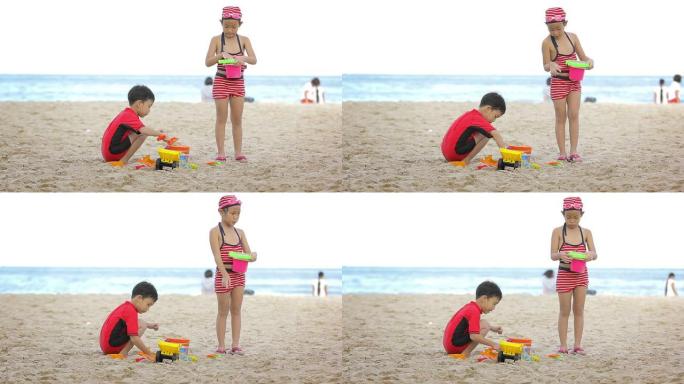 玩沙子的小男孩和小女孩