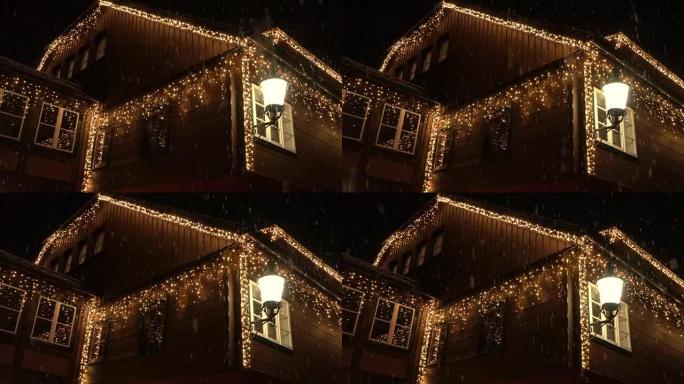特写: 圣诞节晚上用白色发光灯装饰的大房子