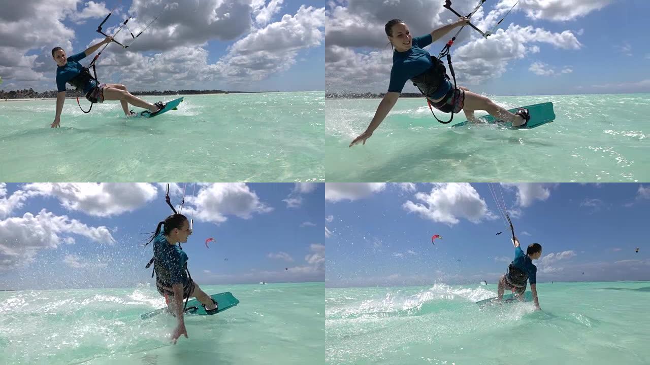 慢动作: 快乐冲浪女孩风筝冲浪和手工拖动泼水