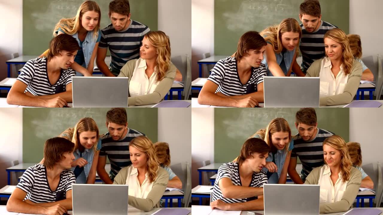 一组学生在教室使用笔记本电脑