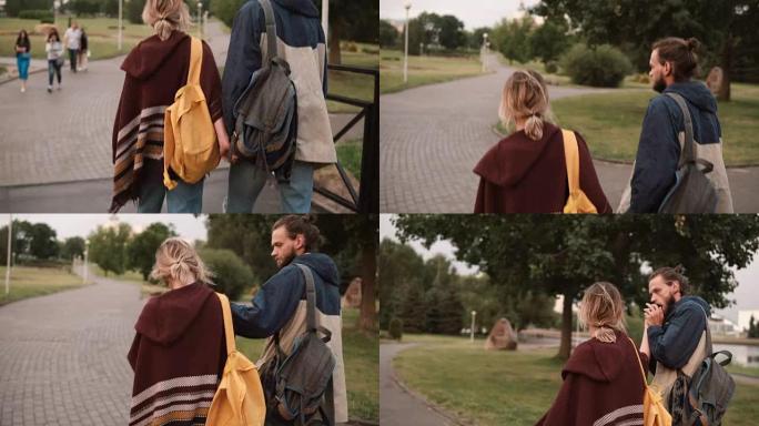 年轻美丽的夫妇牵着手在公园散步的特写背景图。男人亲吻女人的手。浪漫约会