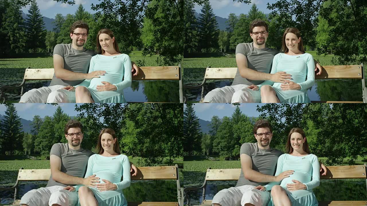 肖像: 可爱的期待年轻夫妇快乐地坐在木凳上微笑