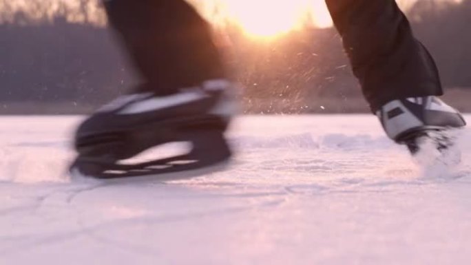 4k十几岁的男孩滑冰，在冰冻的湖面上旋转，慢动作