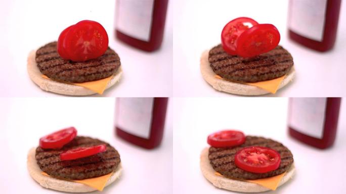 切成薄片的西红柿落在厨房的汉堡上