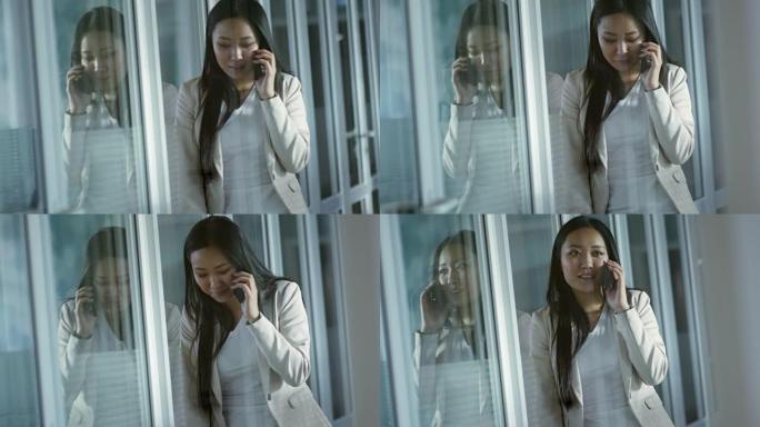 亚洲女商人在工作中通过手机讲话