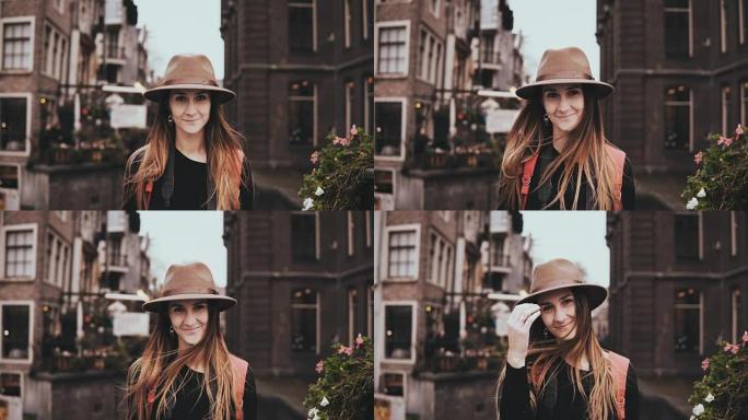 快乐的欧洲女孩看着相机的肖像。迷人的年轻女士戴着凉爽的帽子，留着微笑的长发。4K