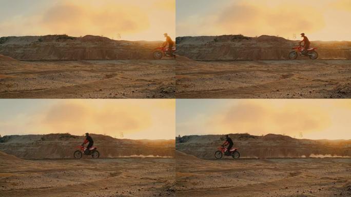 侧面拍摄的专业自行车骑手驾驶他的FMX摩托车在桑迪越野赛道上。风景优美的日落是背景。