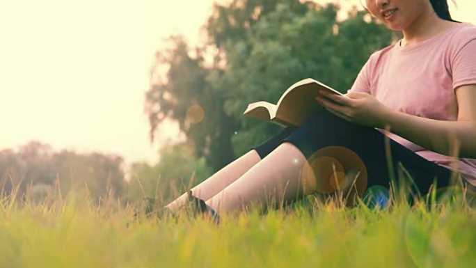 妇女坐在草地上读书
