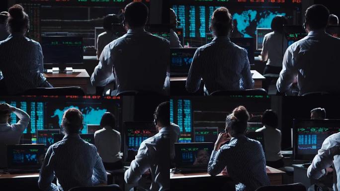 股票经纪人在屏幕上观看交易所上市
