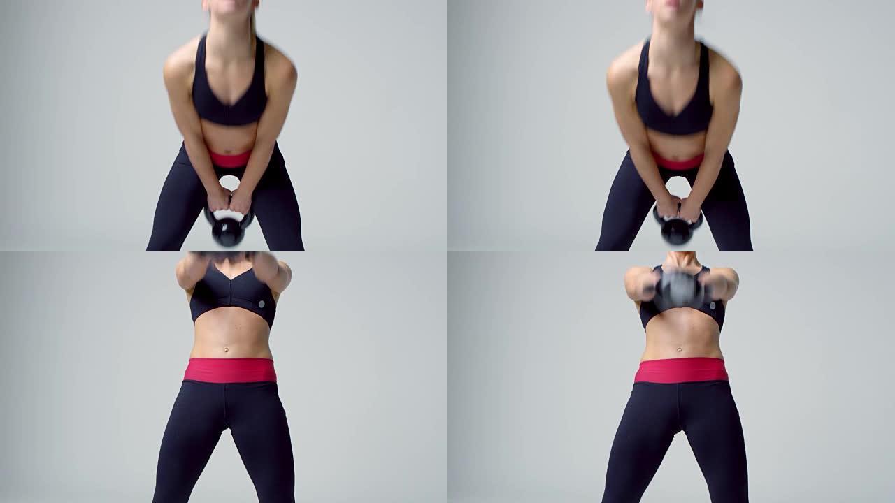 运动金发女子用壶铃锻炼，前视图，在R3D拍摄
