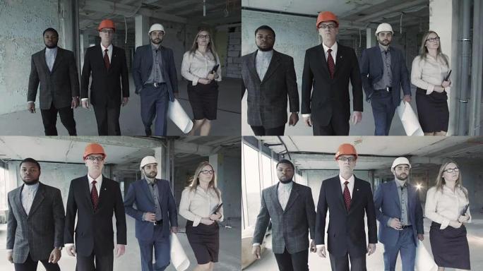 穿着西装、安全帽、移动、直视镜头的建筑商团队。黑人，年迈的工程师