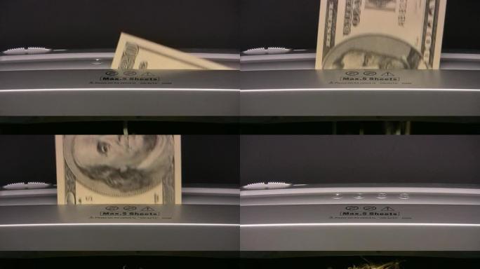 100美元的钞票被扔进碎纸机。通货资金钱