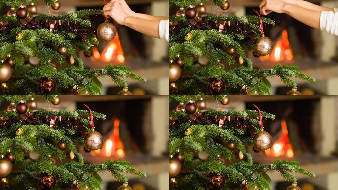 将装饰品放在圣诞树上，壁炉在背景中燃烧