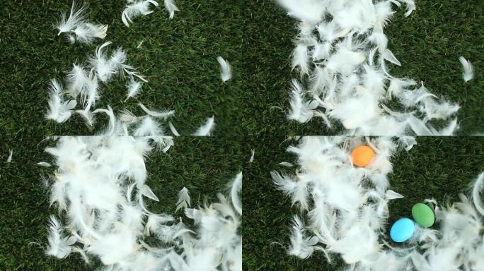 羽毛和复活节彩蛋掉落在绿草上