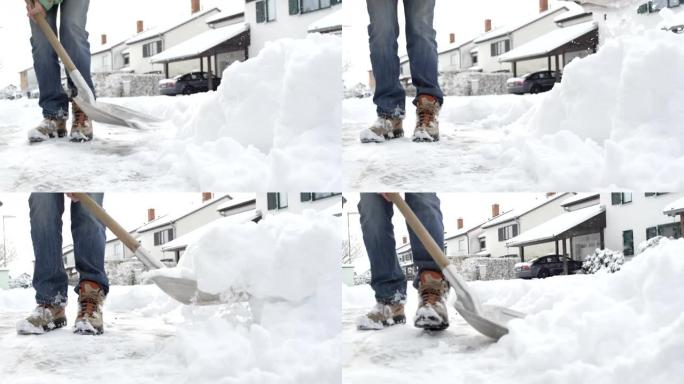 特写: 男子在田园诗般的郊区小镇的房子前清除新鲜的积雪