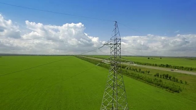 空中高压铁塔夏季蓝天背景绿草全景飞出