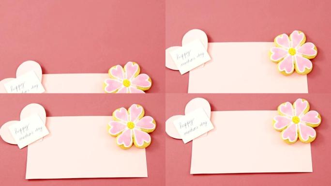 花形饼干，红色信封上的心形卡片，粉红色背景