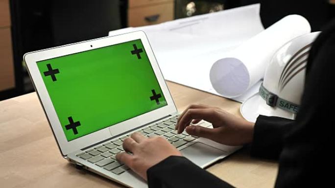 工程师使用带有绿屏的笔记本电脑