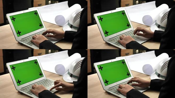 工程师使用带有绿屏的笔记本电脑