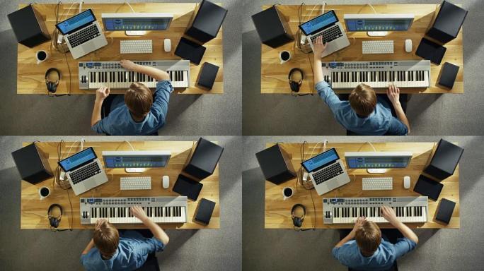 一位音乐家在他的工作室创作音乐，用音乐键盘演奏的俯视图。他在创作音乐的同时跳舞。他的工作室阳光明媚，