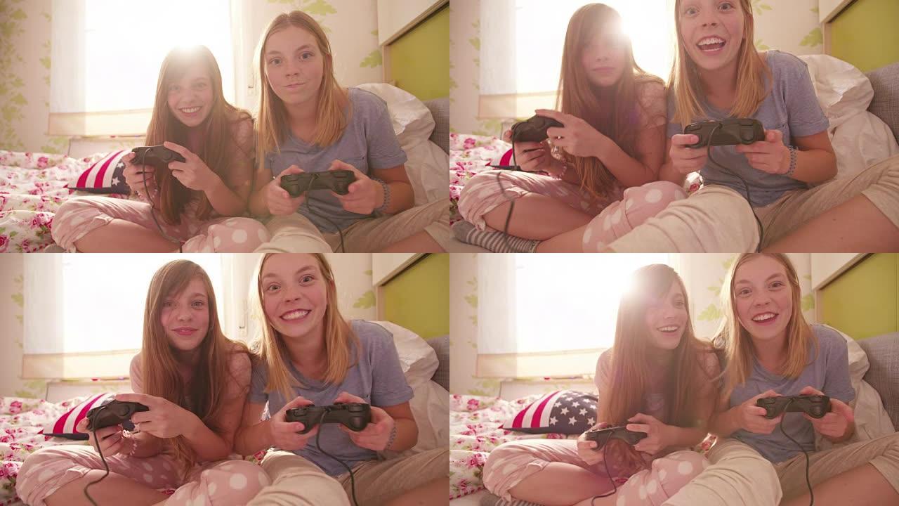 女孩们一起在卧室里玩电脑游戏
