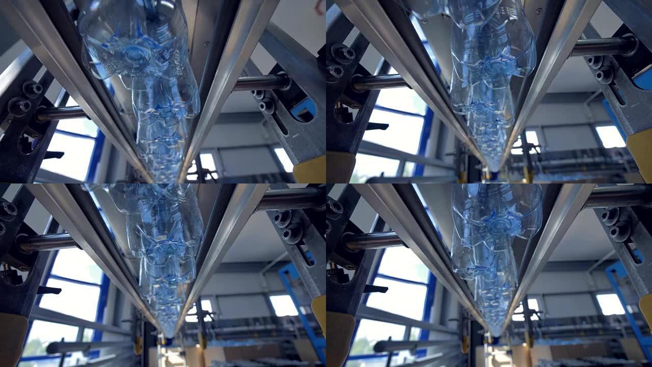 空水瓶在自动模式下在工厂导轨上移动。4K。