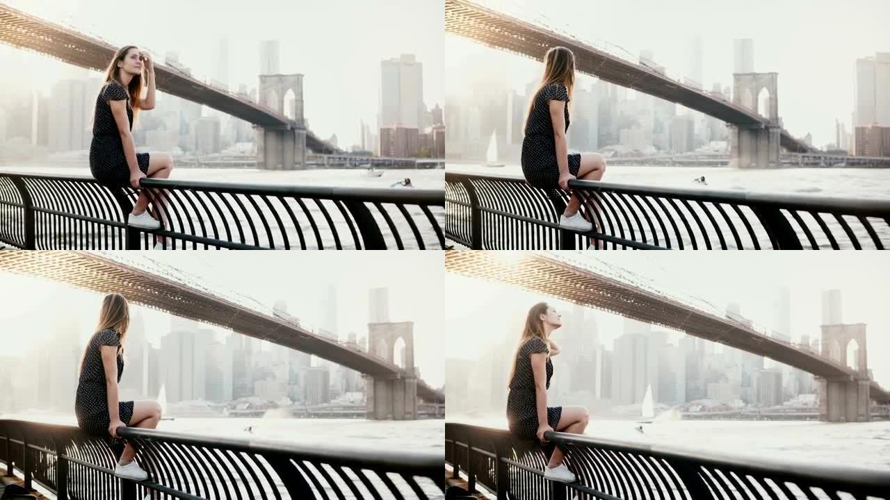 美丽的高加索年轻女子坐在纽约布鲁克林大桥的河堤围栏上，喷气式飞机经过4k