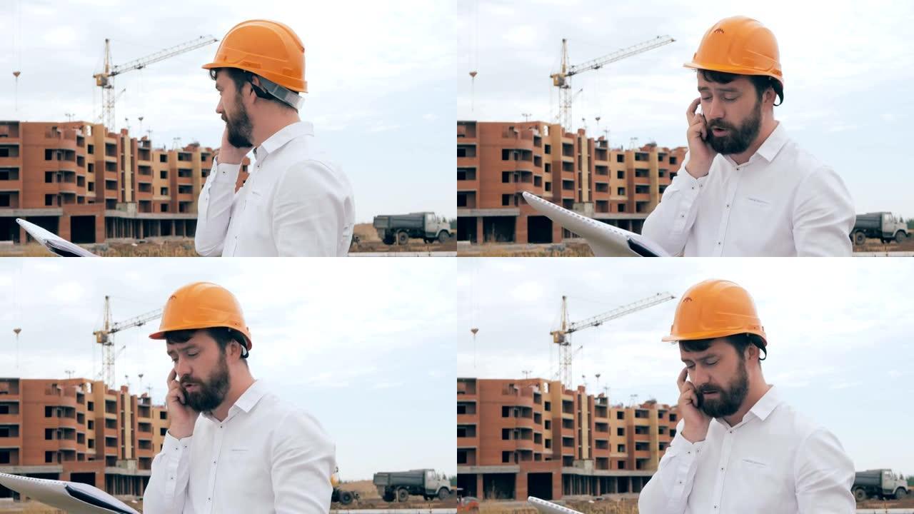 建筑师在建筑工地上用手机聊天