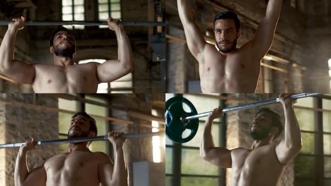 一个肌肉赤裸的男人举起沉重的杠铃和在工业健身房大楼做军事压健美锻炼的特写。