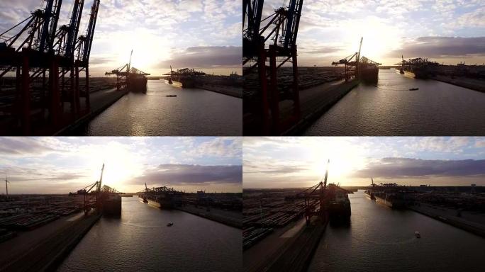 汉堡集装箱港口，在日落时装有船舶和起重机