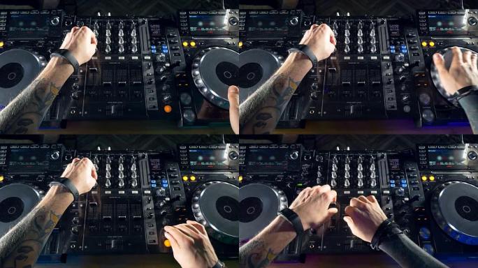 DJ在电子夜总会派对上双手混音。