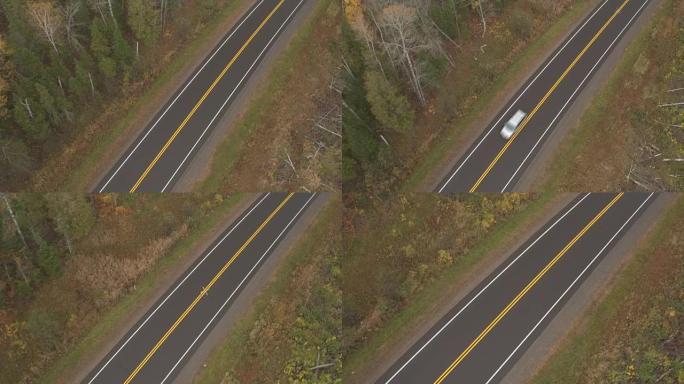 空中: 穿过乡村的高速公路上的黄色和白色线道路标记