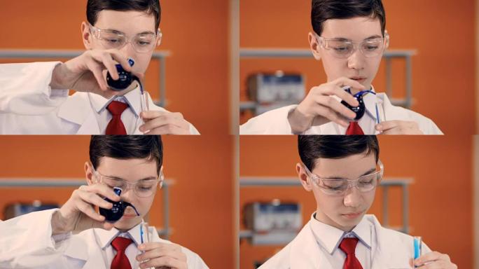 科学课上的小男孩在试管中混合液体。