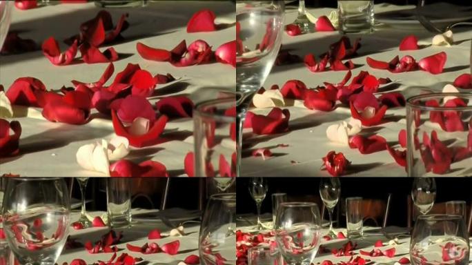 桌上的红花花瓣和玻璃杯（宽屏16:9）