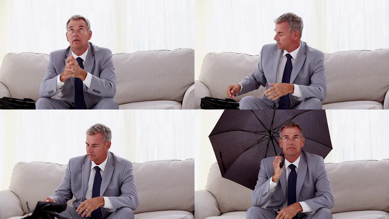 商人坐在沙发上打开雨伞