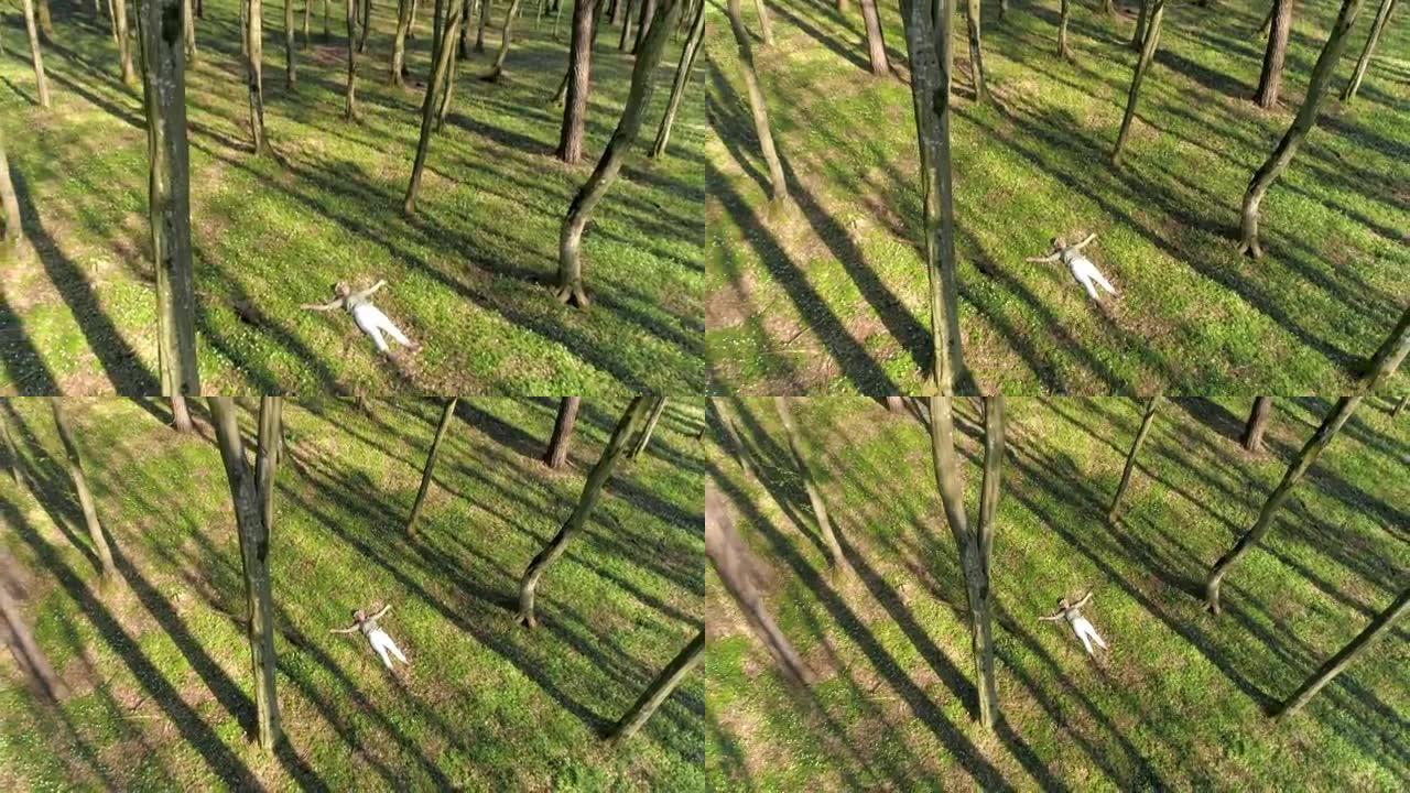 空中女人躺在森林里的春天野花中