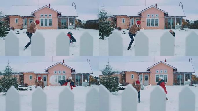 年轻美丽的夫妇跑出家门，走进覆盖着新鲜积雪的院子，他们旋转着跳舞。快乐的年轻人在神奇的冬天。