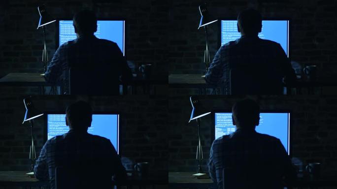 年轻的程序员晚上坐在显示器前，正在开发代码。