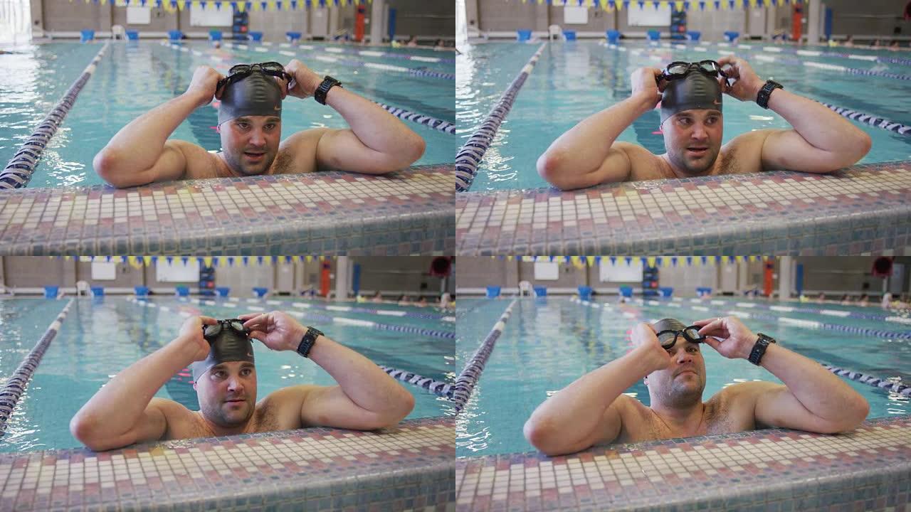 男性游泳运动员戴上护目镜