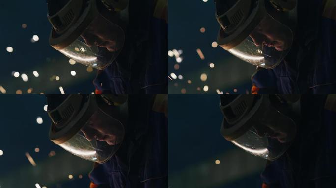 一个重工业工人在角磨机上使用金属时，戴着能反射火花的面具的肖像。