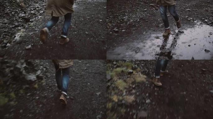 男性穿脚靴的特写镜头。焦虑的人逃离某人