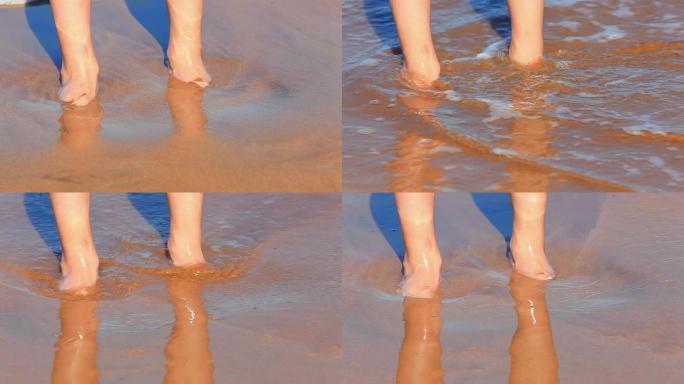 海浪在海滩上冲刷着年轻女孩的双脚