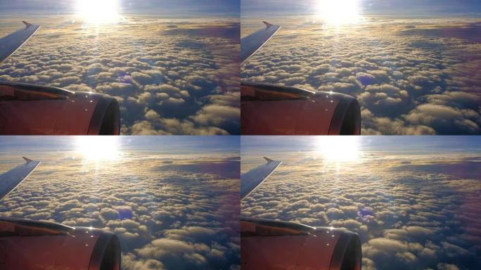 飞机在日落时飞越云层