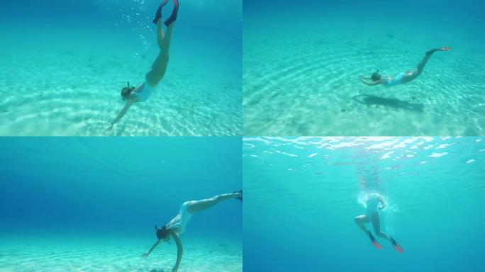 女士浮潜，在蓝色的海洋中水下游泳