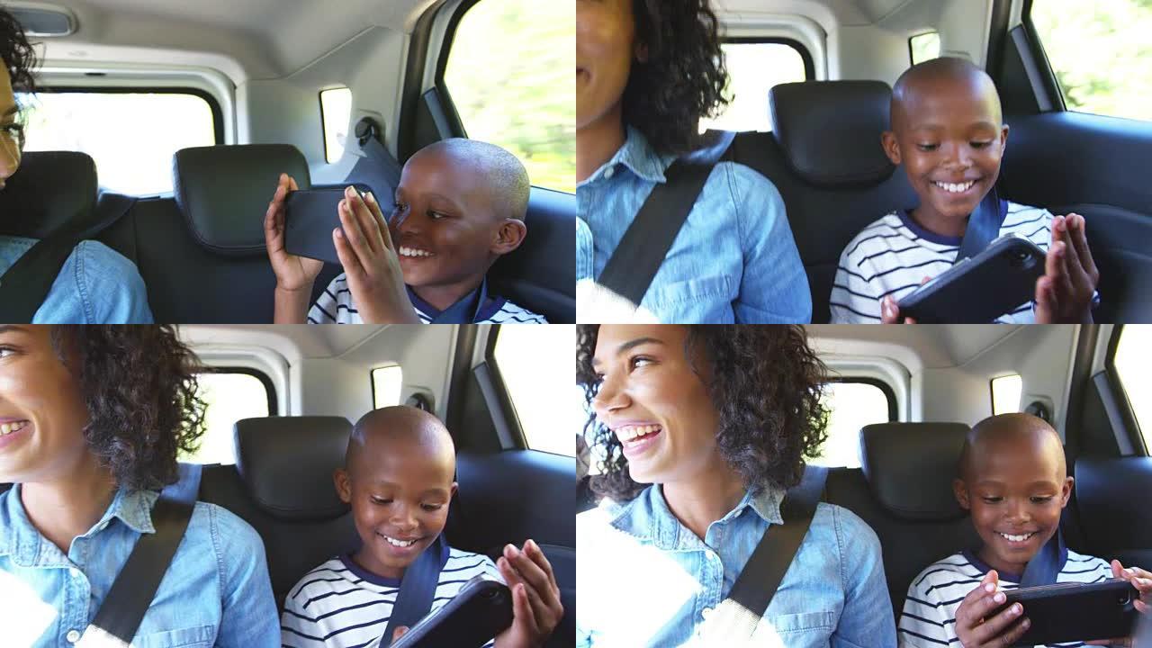 年轻的黑人母亲和男孩在汽车上进行公路旅行