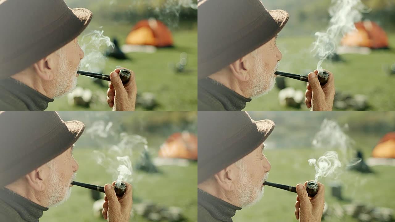 老人在湖边露营时抽烟